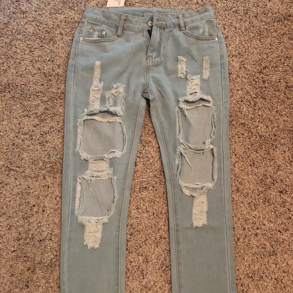 Ripped light wash jeans. Small / medium
